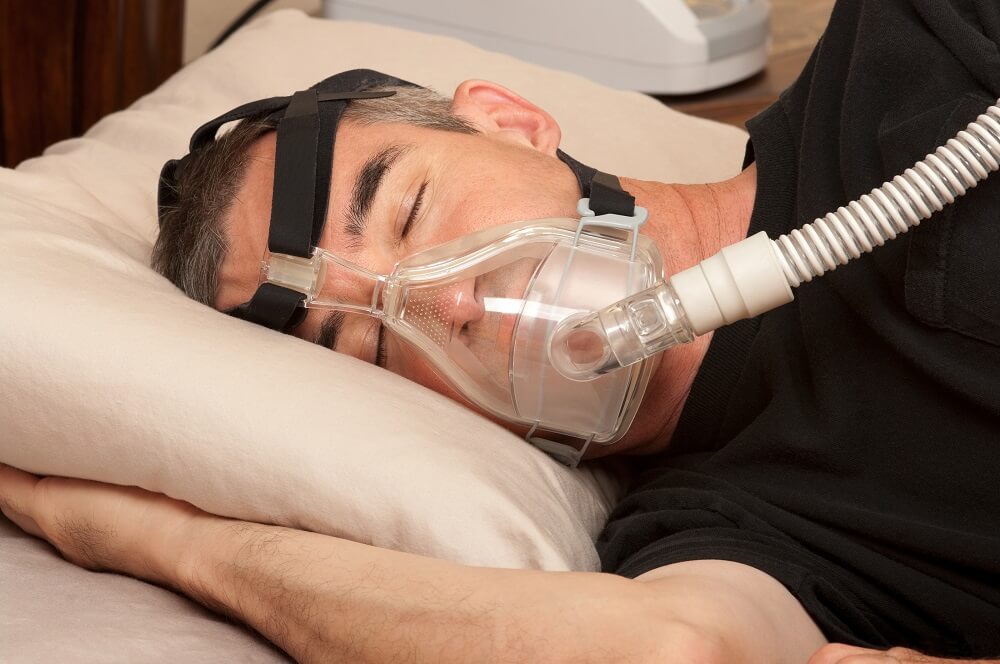 man with sleep apnea machine on face