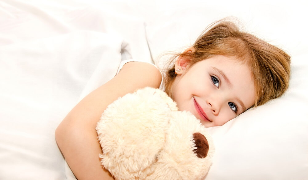 girl smiling in bed