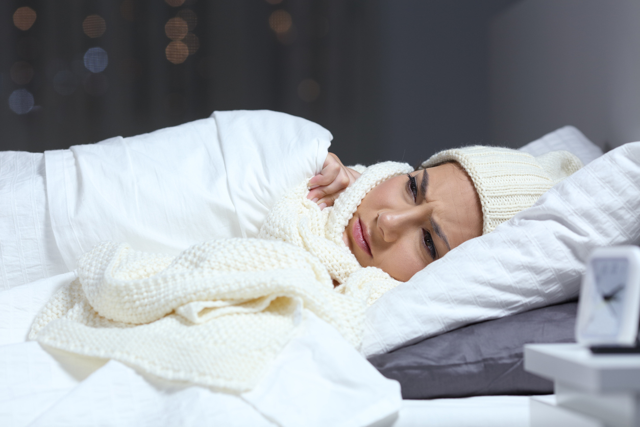 Sick woman trying to learn how to sleep with a cold
