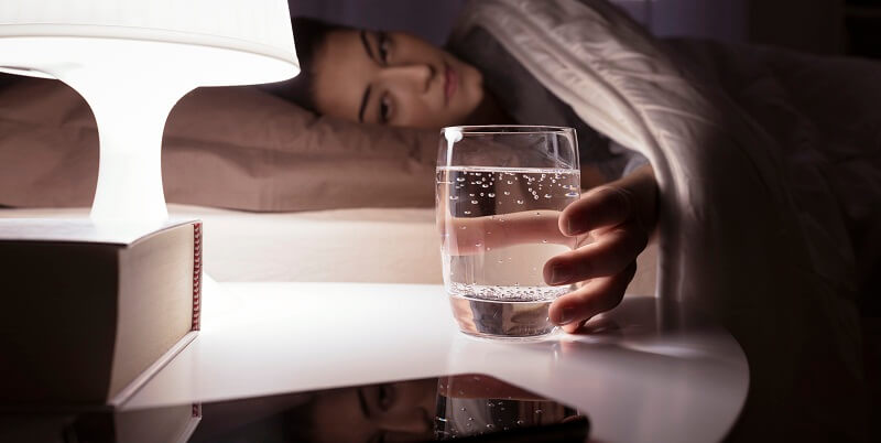 glass of water being held by woman