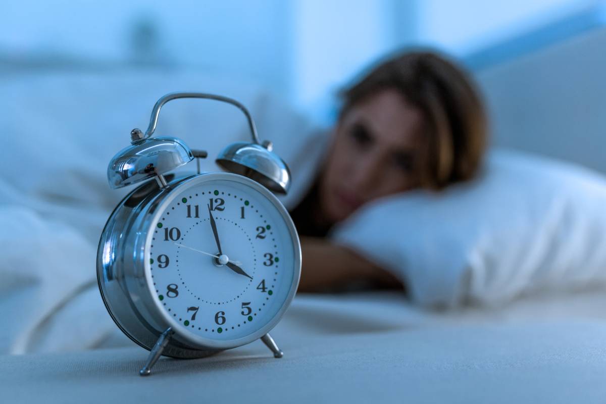 woman and alarm clock