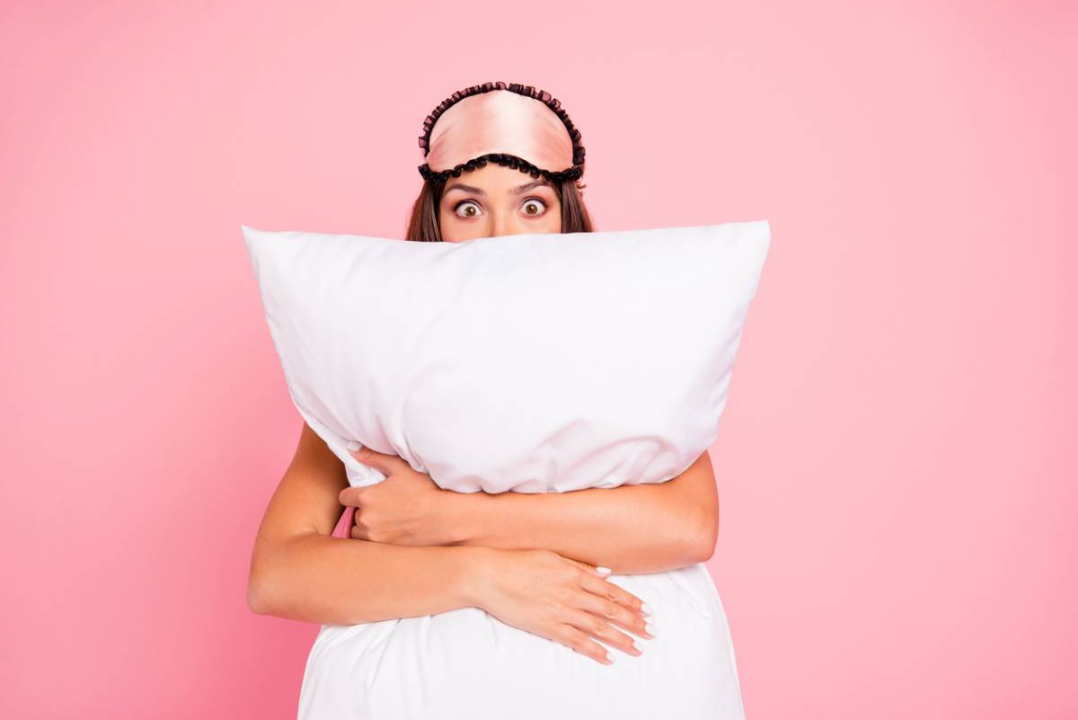 womam holding white pillow