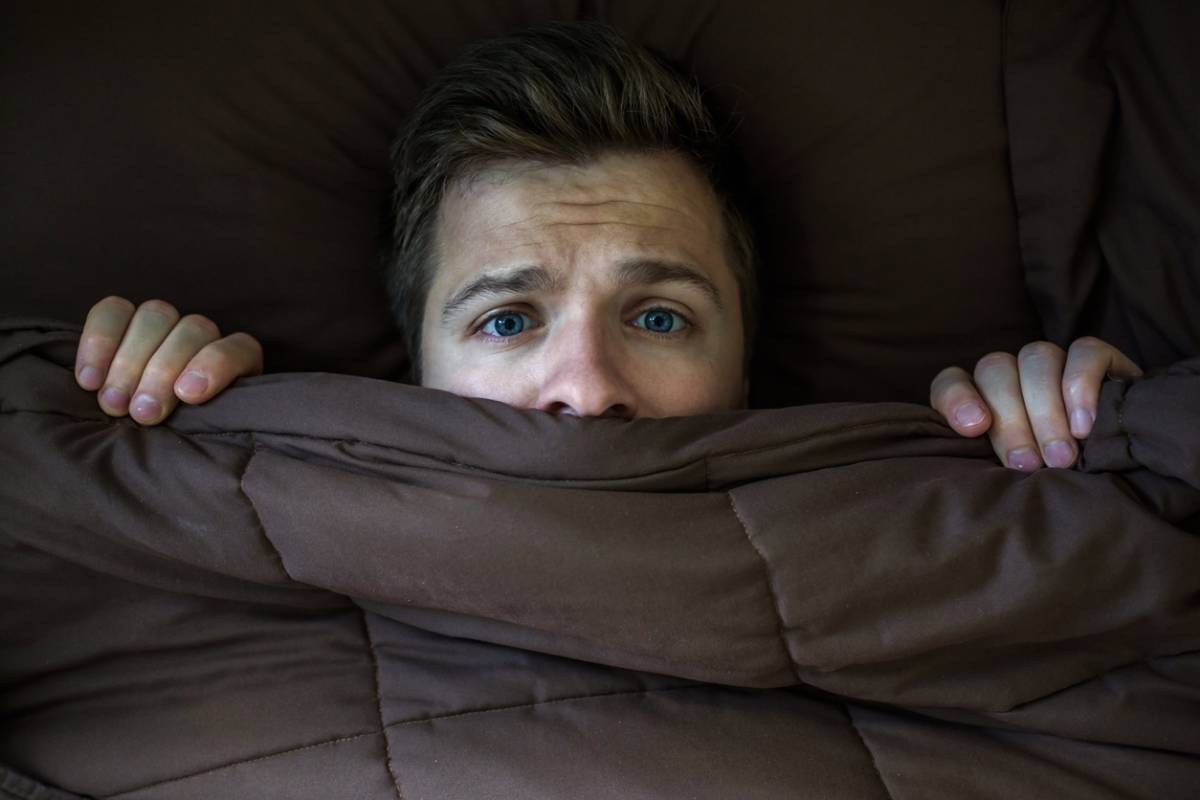 man experiencing sleep paralysis or false awakening.