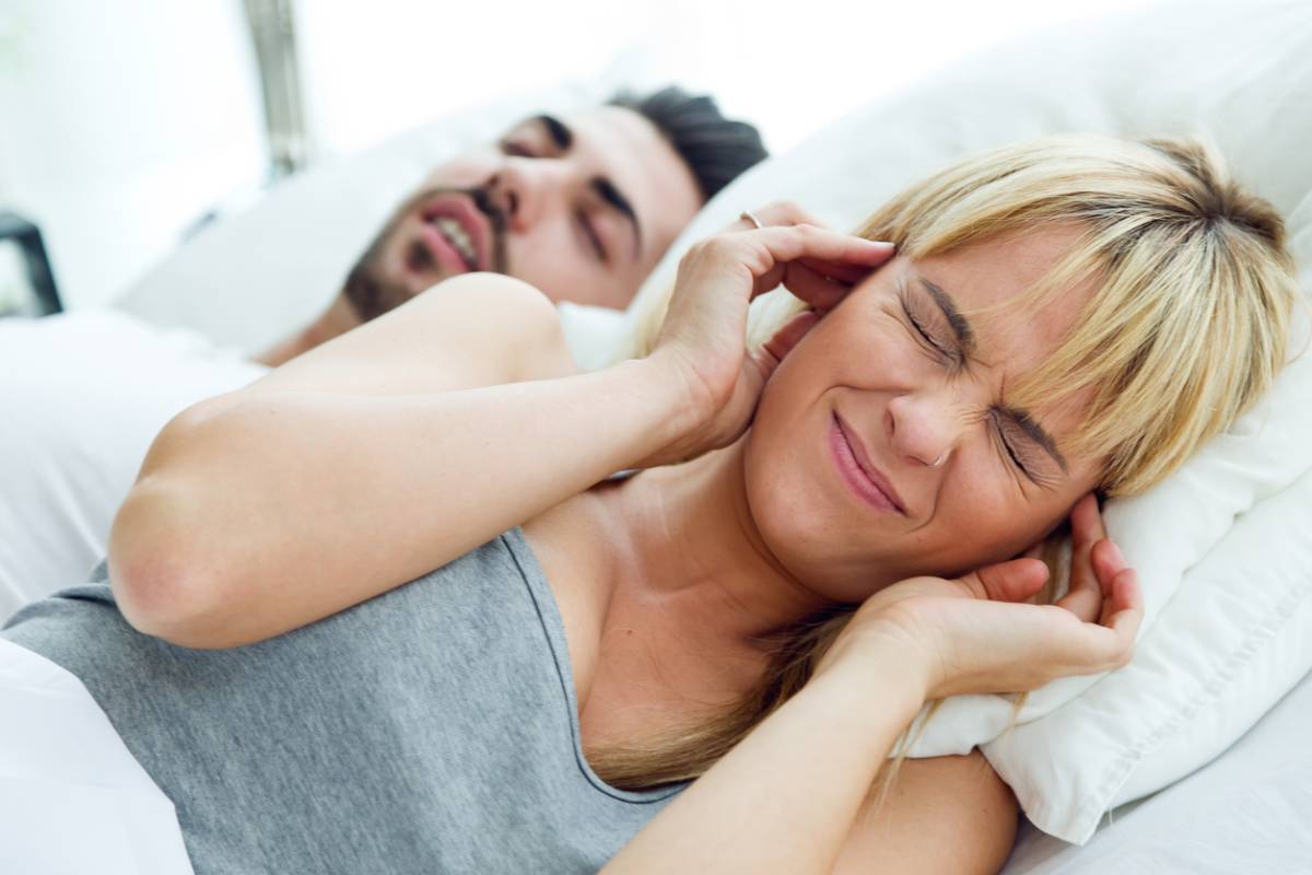 Woman worrying that her husband snoring may shorten her life.
