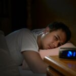 Man having trouble sleeping because he works one of the worst jobs for sleep