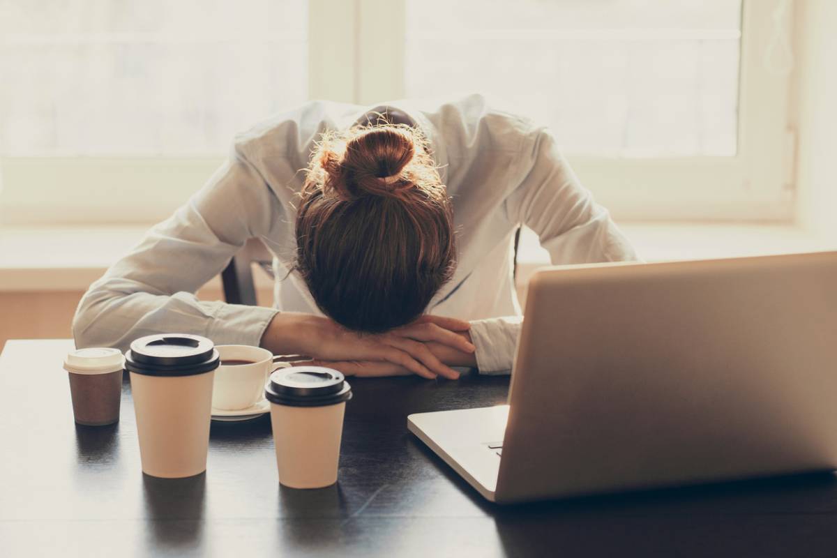 Woman suffering from sleep deprivation at her desk